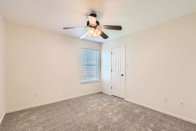 Carpeted spare room with a ceiling fan and baseboards | Image 24