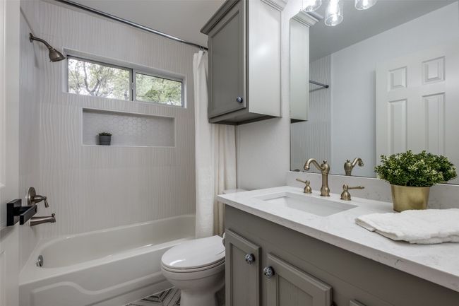 Full bathroom with shower / tub combo, vanity, and toilet | Image 17