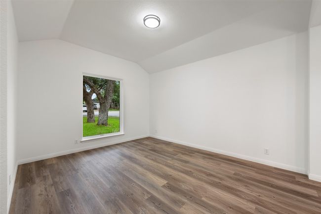 Spare room with vaulted ceiling and wood finished floors | Image 6