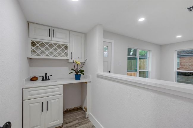 Beautiful wet bar is conveniently located between the breakfast area and living room. | Image 11