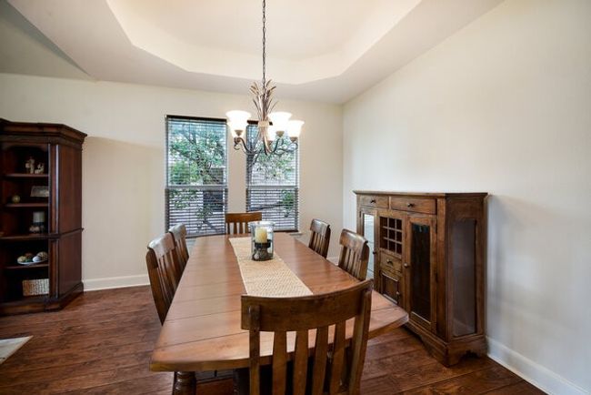 Dining room with baseboards, dark wood-style floors, and a chandelier | Image 6