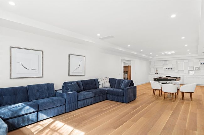 Living area with light wood-type flooring, visible vents, recessed lighting, a tray ceiling, and baseboards | Image 30