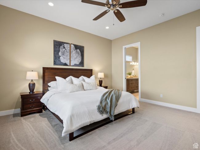 Bedroom featuring light carpet, baseboards, recessed lighting, ensuite bathroom, and ceiling fan | Image 20