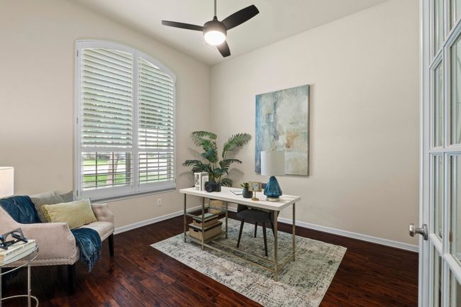 Office area with dark wood-style floors and a ceiling fan | Image 19