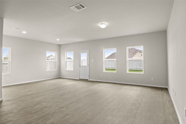 Unfurnished living room with recessed lighting, visible vents, baseboards, and wood finished floors | Image 9