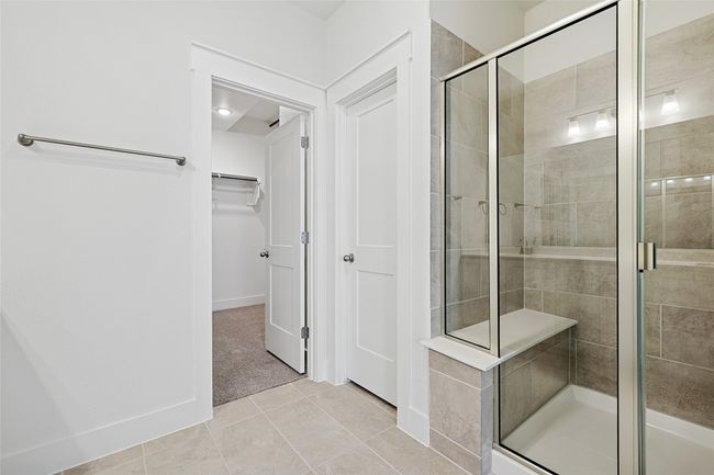 Bathroom featuring a shower with shower door and tile patterned floors | Image 21