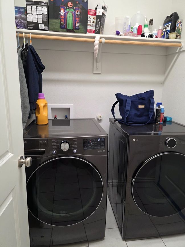 Laundry area with washer and dryer and light tile patterned floors | Image 6