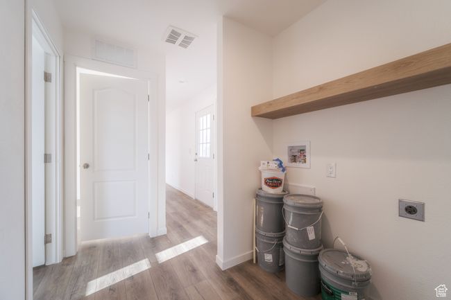 Laundry room featuring washer hookup, wood finished floors, visible vents, and hookup for an electric dryer | Image 20