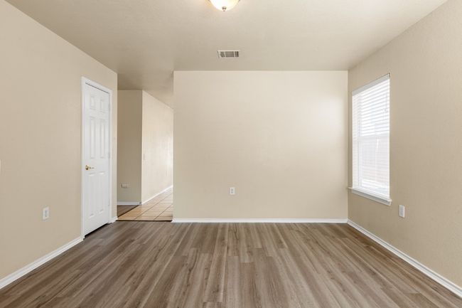 Unfurnished room featuring wood finished floors and baseboards | Image 5
