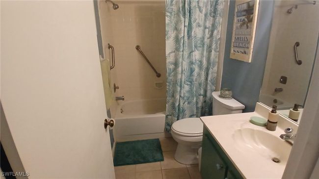 Master Bathroom Full bathroom with tile patterned floors, toilet, vanity, and shower / bathtub combination with curtain | Image 7