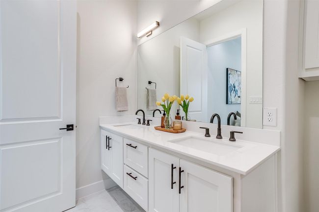 Bathroom featuring double vanity, marble finish floor, a stall shower, and a sink | Image 21