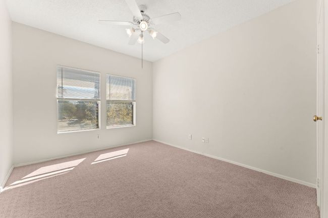 Spare room with baseboards, carpet floors, and a ceiling fan | Image 18