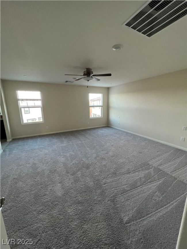 Carpeted spare room featuring a ceiling fan and baseboards | Image 21