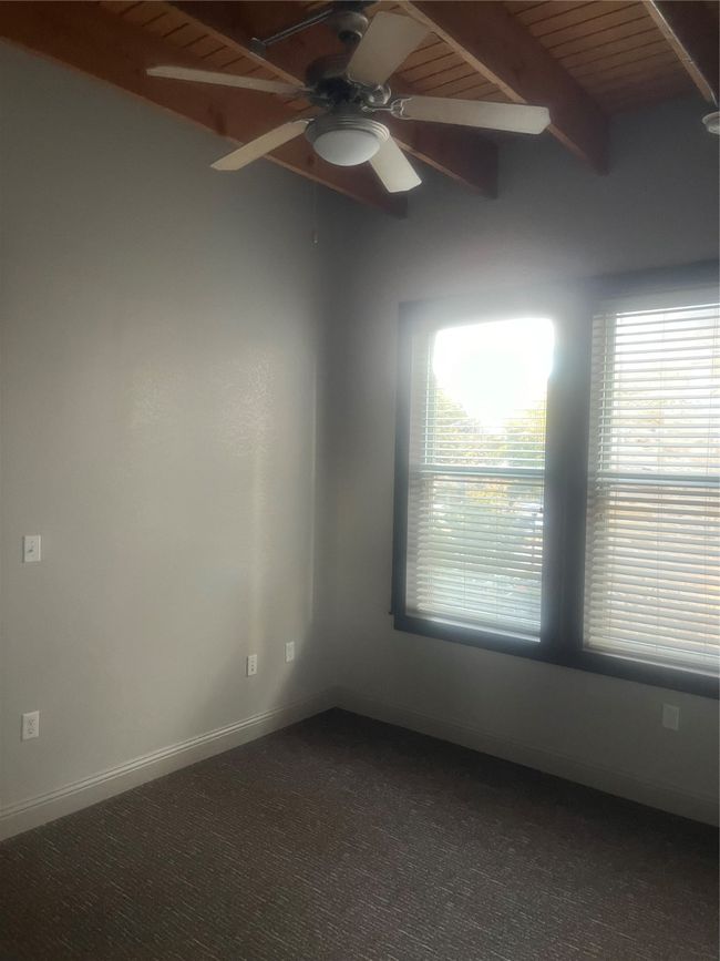 Bedroom with ceiling fan, beam ceiling, and wooden ceiling | Image 8