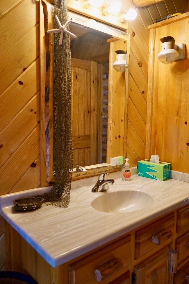 Bathroom featuring wooden walls and vanity | Image 42