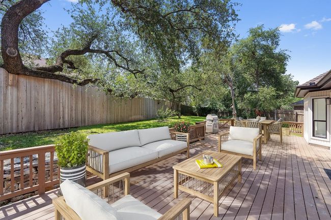 Deck featuring an outdoor hangout area, a fenced backyard, and a grill | Image 30