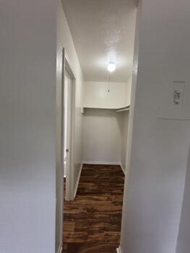 Spacious closet with wood finished floors | Image 8