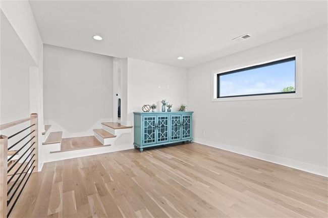 Spare room with wood finished floors, recessed lighting, and stairs | Image 25