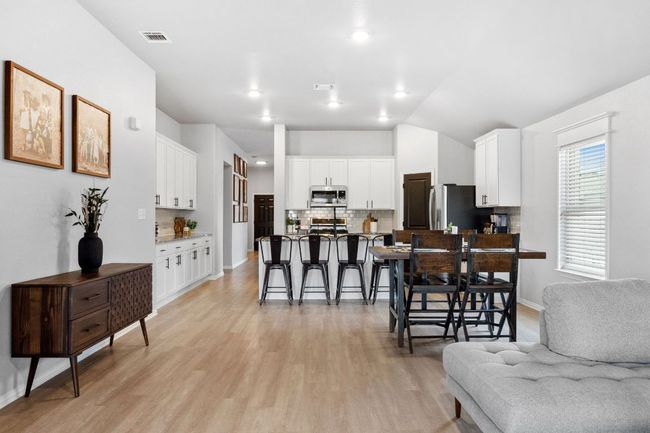Warm, medium toned LVP flooring showcases a low-maintenance, up-to-date design. | Image 13