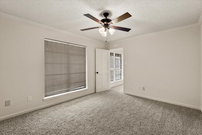 Carpeted empty room with ornamental molding and a textured ceiling | Image 19