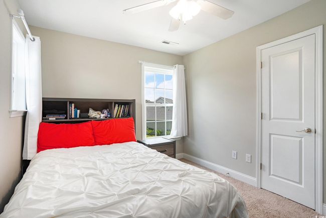 Bedroom with carpet and ceiling fan | Image 21