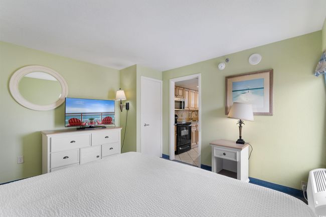 Bedroom featuring a sink, connected bathroom, and baseboards | Image 20