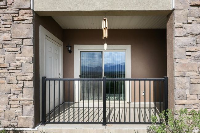 Entrance to property with stone siding and stucco siding | Image 16