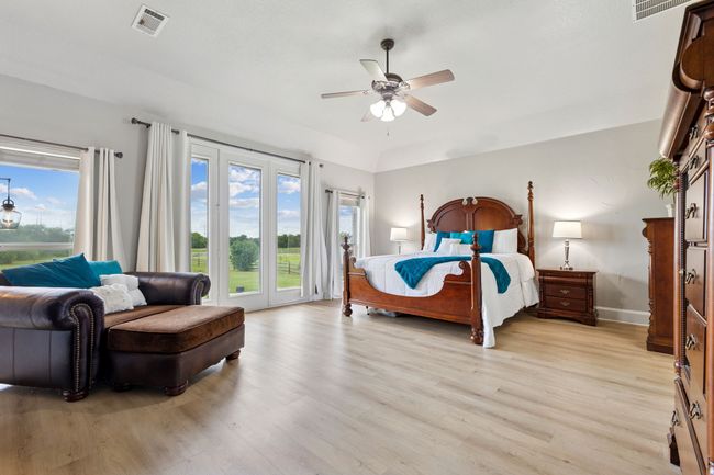Bedroom with access to outside, light wood-type flooring, baseboards, and ceiling fan | Image 19