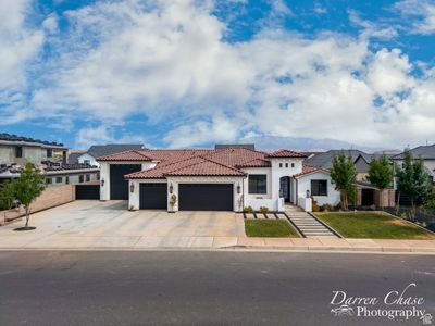 Mediterranean / spanish-style home featuring a garage | Image 1