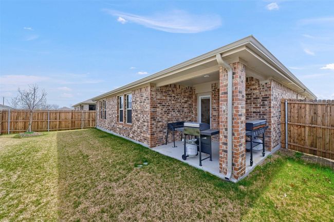 Rear view of property featuring brick siding, a patio area, and a fenced backyard | Image 28