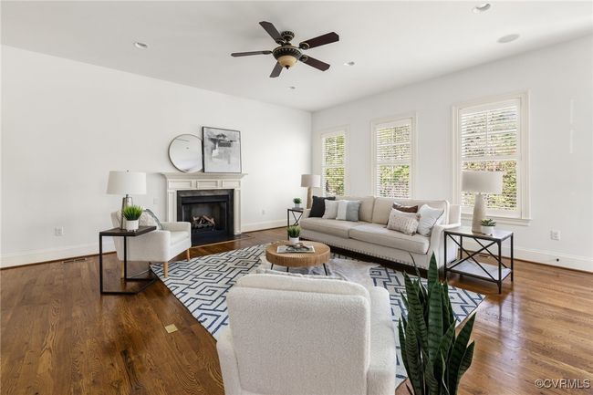 10'Ceilings, 8' door, Gas fireplace, Site finished hardwood floors, Ceiling fan with light fixture, Recessed lighting, Floor outlet, Access to rear patio, Surround sound | Image 16