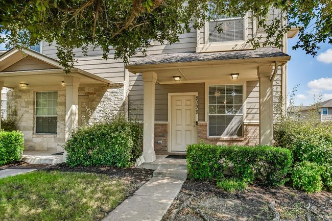 Doorway to property with stone siding and roof with shingles | Image 8
