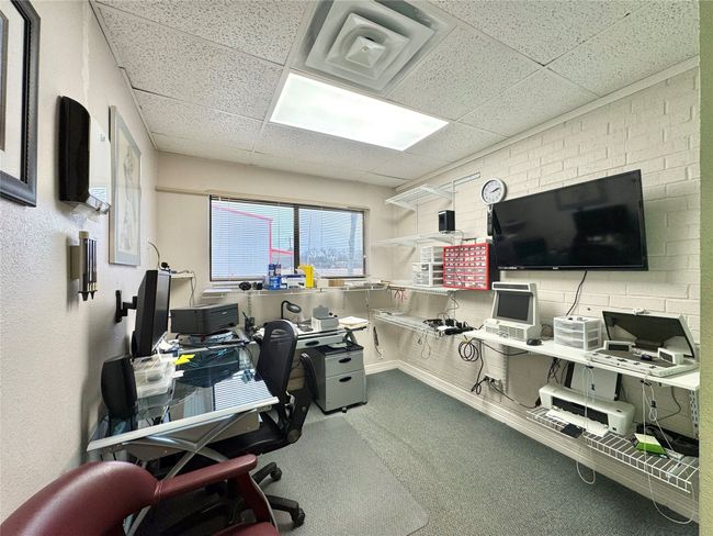 Carpeted office featuring a drop ceiling | Image 34