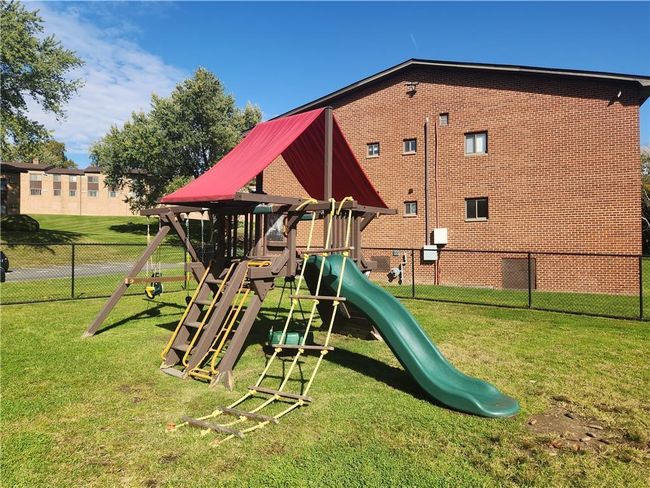 Community playground featuring fence and a lawn - located next to completely fenced dog play area | Image 23