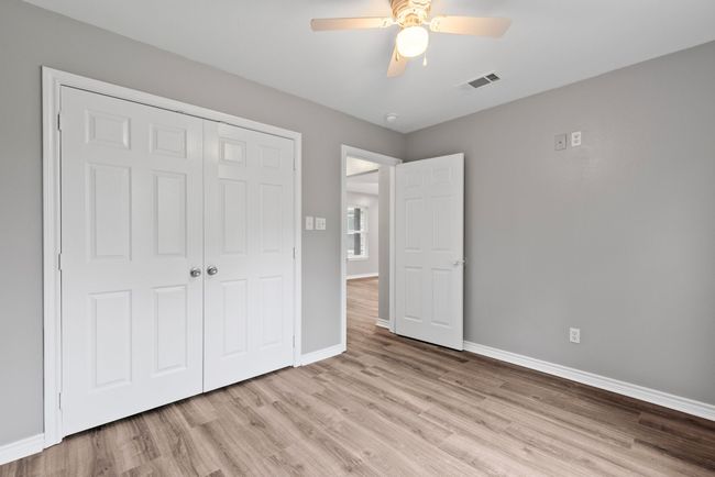 Unfurnished bedroom with wood finished floors, a closet, and ceiling fan | Image 18