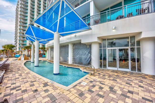 View of pool with a patio area | Image 26