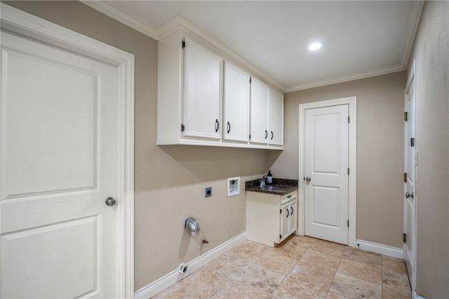 Clothes washing area with washer hookup, cabinet space, ornamental molding, gas dryer hookup, and electric dryer hookup | Image 19