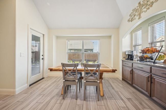 Dining room featuring plenty of natural light, wood finish floors, and lofted ceiling | Image 11