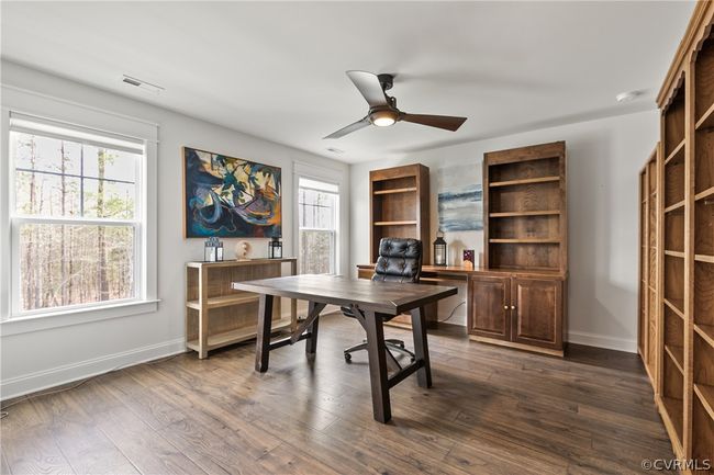 Office with ceiling fan, built in shelves, and dark wood-type flooring | Image 33