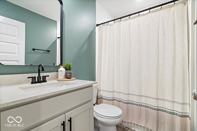 full bath with vanity and a shower with shower curtain | Image 20