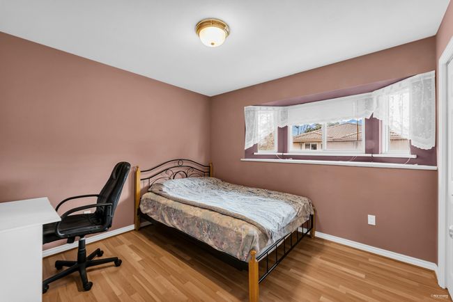 Bedroom with baseboards and wood finished floors | Image 14