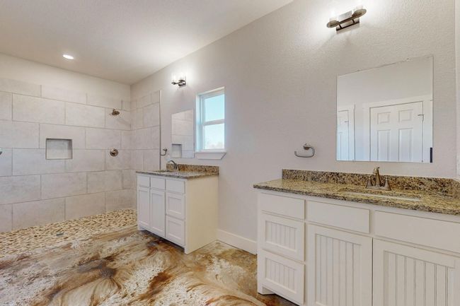 Bathroom featuring walk in shower and two vanities | Image 17