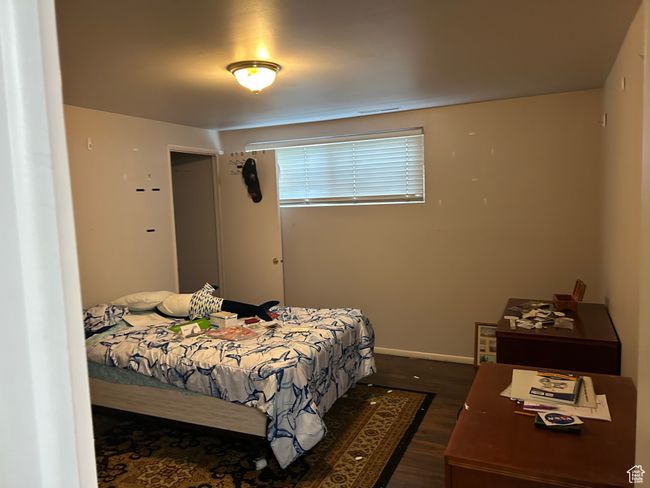 Bedroom featuring dark wood finished floors and baseboards | Image 12