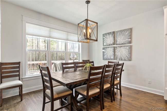 Dining area with dark hardwood / wood-style floors and an inviting chandelier | Image 17