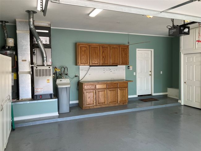 Nice built in cabinets with peg board. | Image 30