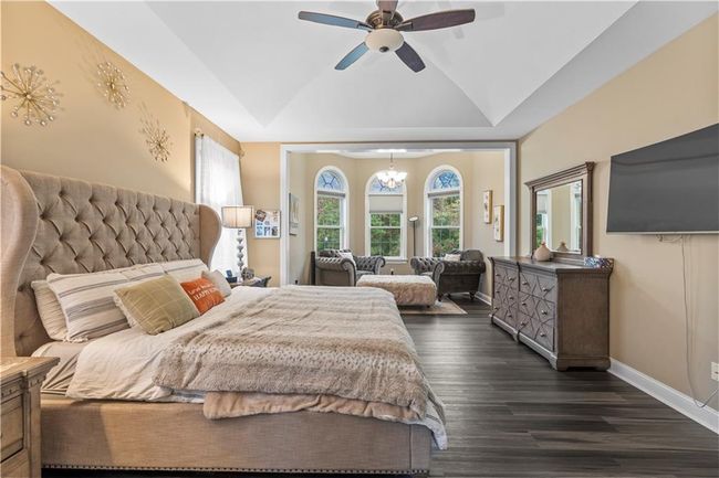 Bedroom featuring dark wood-type flooring, baseboards, lofted ceiling, and a ceiling fan | Image 18