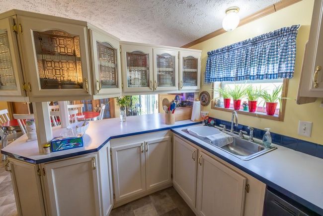 Kitchen with light countertops, a sink, and plenty of natural light | Image 8
