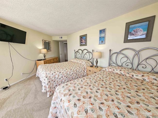 Carpeted bedroom featuring a textured ceiling and baseboards | Image 30