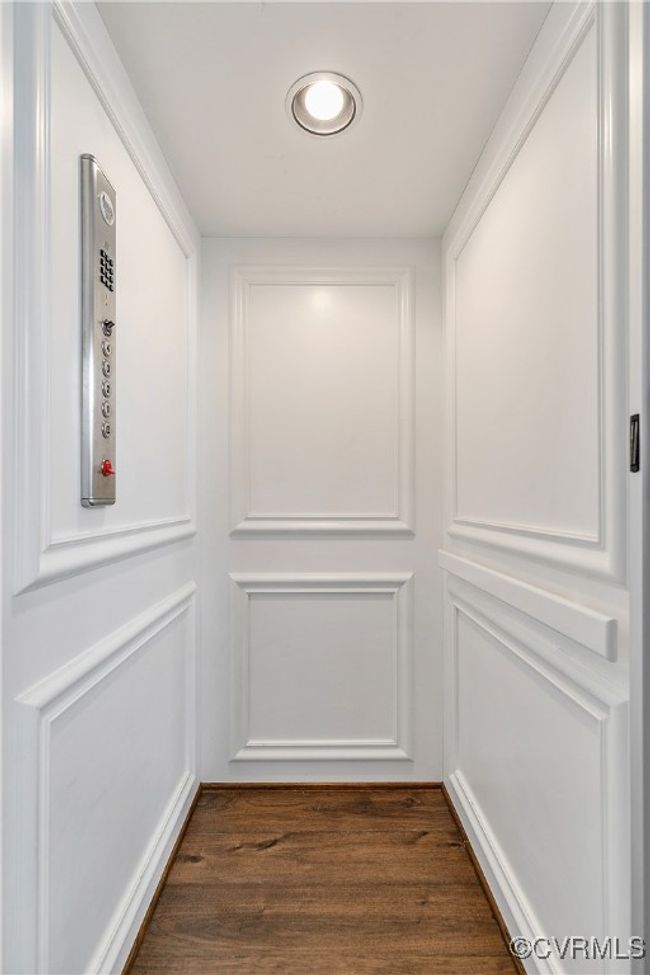 Interior details featuring elevator and wood finished floors | Image 18