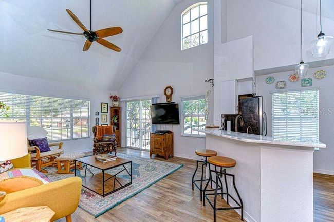 Your new living room has views of lake from the windows and vaulted ceiling. | Image 18